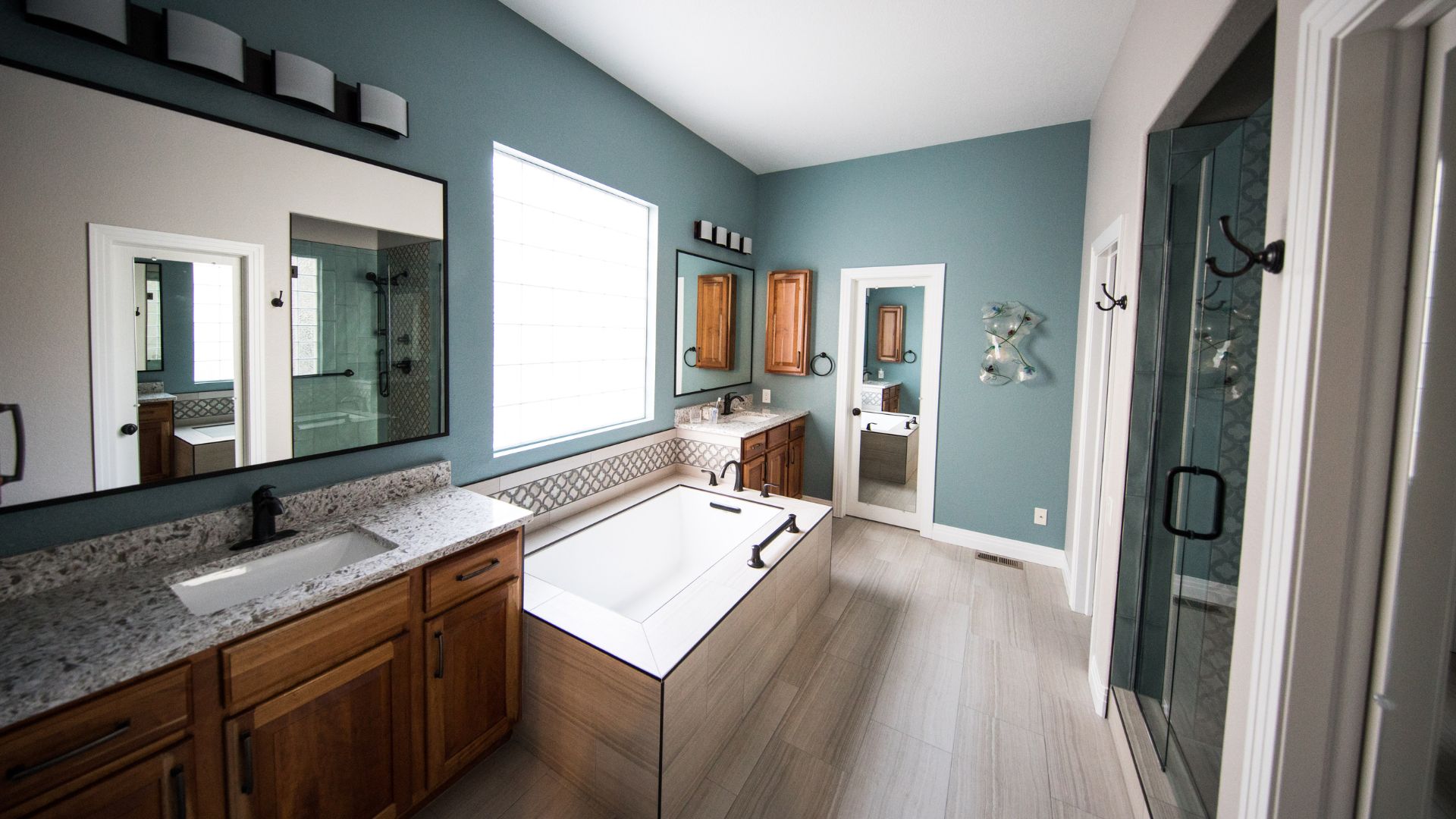 A bathroom with blue walls and a large mirror
