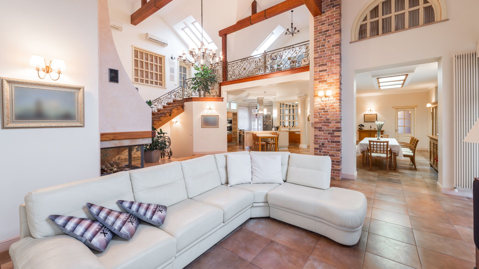 A living room with a white couch and a fire place